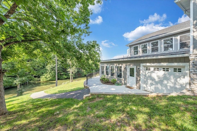 1620 Stripers Cove Rd, Goodview, VA 24095 - view of grassy yard featuring a garage and a water view