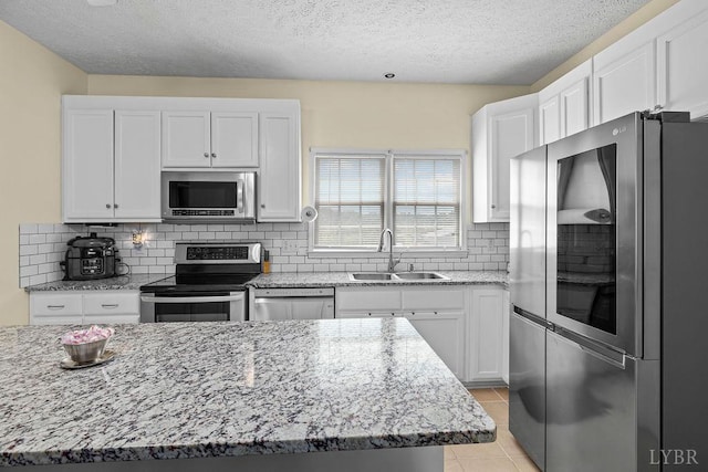 4710 Hummingbird Ln, Concord, VA 24538 - kitchen with appliances with stainless steel finishes, a sink, white cabinetry, and a textured ceiling