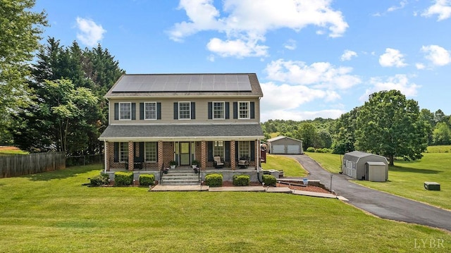4710 Hummingbird Ln, Concord, VA 24538 - view of front of property featuring an outdoor structure, a porch, solar panels, a garage, and brick siding