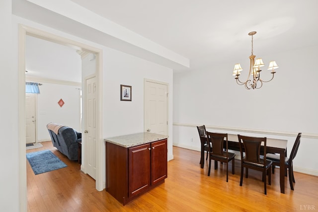 824 Wiggington Rd Unit 303, Lynchburg, VA 24502 - dining space with light wood-type flooring, a chandelier, and baseboards