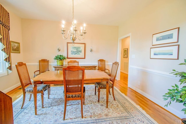 dining room featuring a chandelier and light wood-type flooring