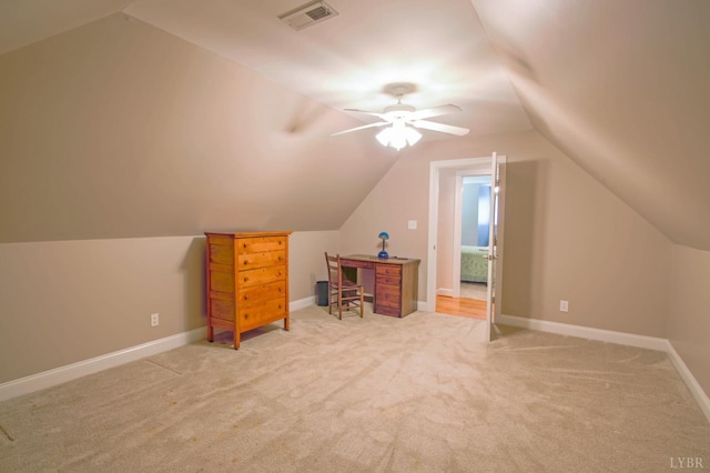 additional living space with lofted ceiling, light carpet, and a ceiling fan