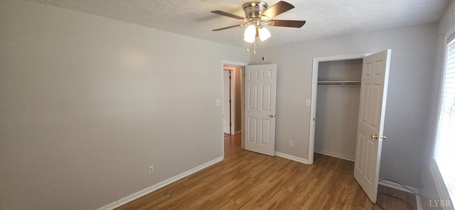 511 Bent Oak Ct, Lynchburg, VA 24502 - unfurnished bedroom featuring wood finished floors, a closet, a textured ceiling, and a ceiling fan
