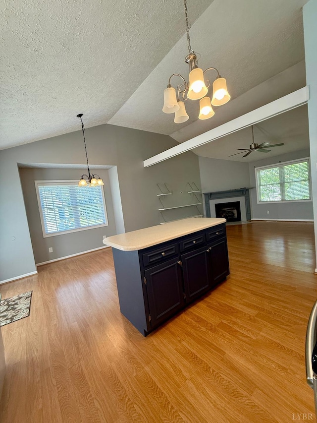 511 Bent Oak Ct, Lynchburg, VA 24502 - kitchen with a chandelier, dark cabinetry, light wood-style floors, open floor plan, and light countertops