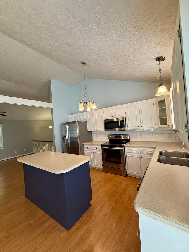 511 Bent Oak Ct, Lynchburg, VA 24502 - kitchen with appliances with stainless steel finishes, lofted ceiling, a textured ceiling, white cabinets, and wood finished floors