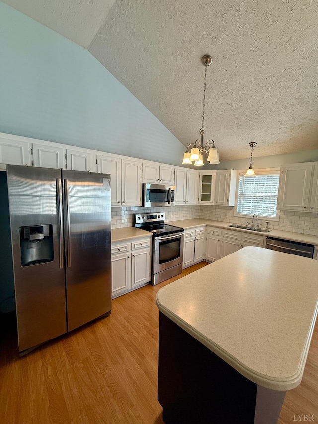 511 Bent Oak Ct, Lynchburg, VA 24502 - kitchen with stainless steel appliances, a chandelier, lofted ceiling, a textured ceiling, and white cabinets