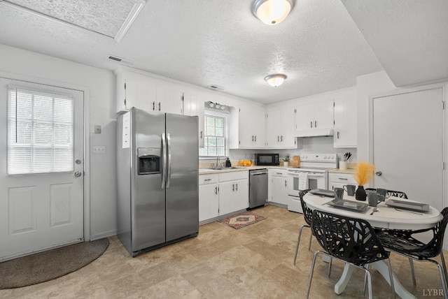 403 W Cadbury Dr, Lynchburg, VA 24502 - kitchen featuring appliances with stainless steel finishes, a textured ceiling, white cabinetry, light countertops, and under cabinet range hood