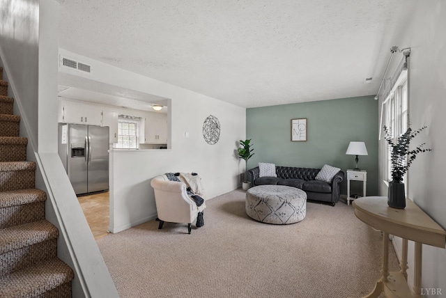 403 W Cadbury Dr, Lynchburg, VA 24502 - living room with a textured ceiling, light colored carpet, and stairway