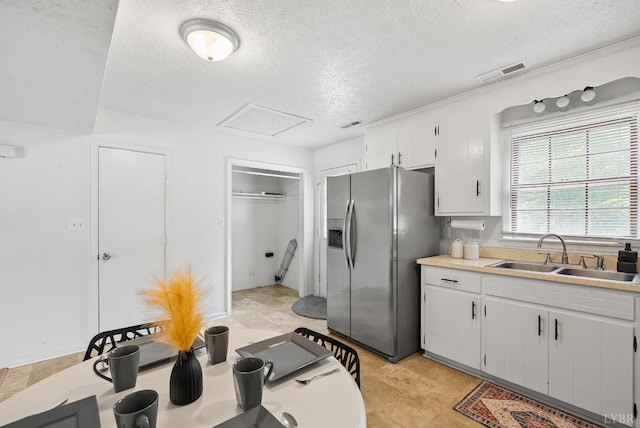 403 W Cadbury Dr, Lynchburg, VA 24502 - kitchen with a sink, stainless steel fridge with ice dispenser, a textured ceiling, light countertops, and white cabinetry