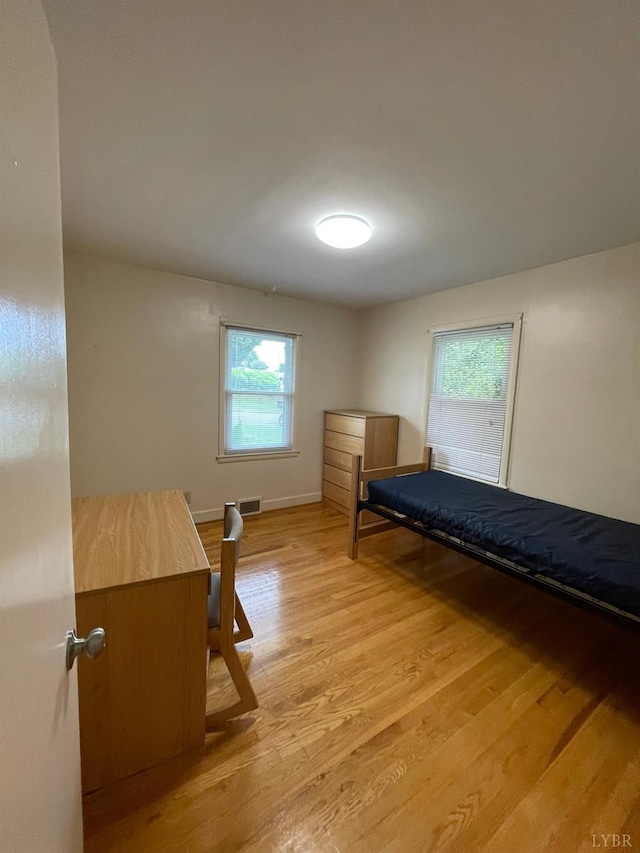 609 Hood St, Lynchburg, VA 24501 - bedroom with light wood-type flooring, multiple windows, and baseboards
