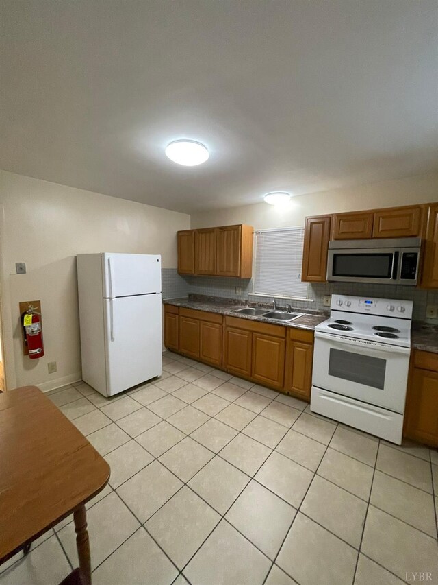 609 Hood St, Lynchburg, VA 24501 - kitchen with white appliances, light tile patterned floors, and brown cabinetry