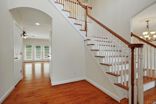103 Waterton Dr, Lynchburg, VA 24503 - stairway with arched walkways, a chandelier, wood finished floors, a ceiling fan, and recessed lighting