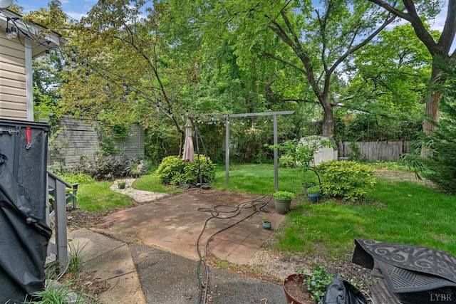 1708 Westwood Ave, Richmond, VA 23227 - fenced backyard with a patio and a storage unit