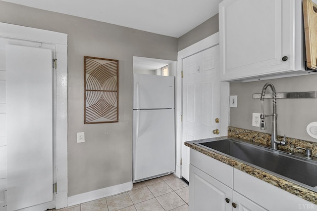 1708 Westwood Ave, Richmond, VA 23227 - kitchen with freestanding refrigerator, white cabinets, and light tile patterned flooring