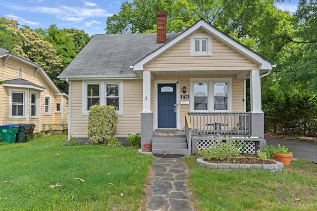 1708 Westwood Ave, Richmond, VA 23227 - bungalow-style house featuring a porch, a chimney, a front lawn, and a shingled roof