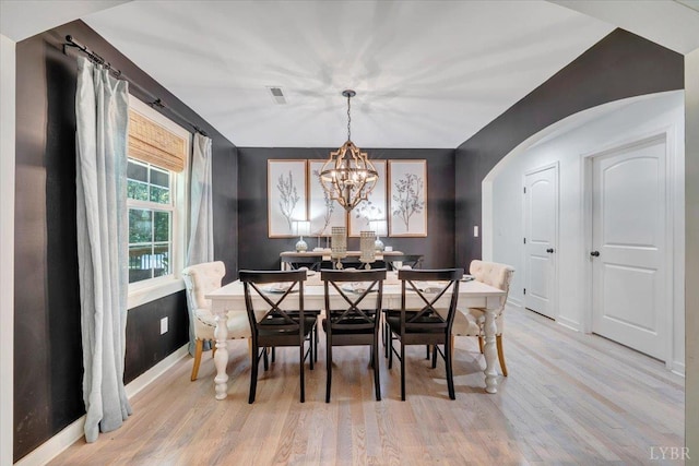 1369 Timberlake Dr, Lynchburg, VA 24502 - dining space featuring light wood finished floors, arched walkways, and a chandelier