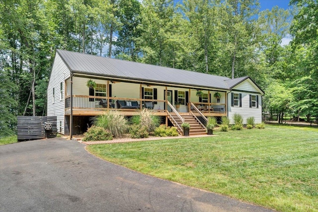 1369 Timberlake Dr, Lynchburg, VA 24502 - single story home featuring a front lawn, covered porch, driveway, a ceiling fan, and stairs