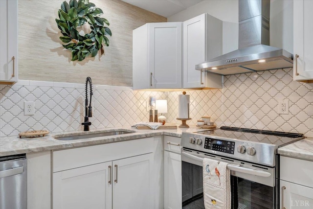 1369 Timberlake Dr, Lynchburg, VA 24502 - kitchen featuring wall chimney range hood, appliances with stainless steel finishes, and white cabinets