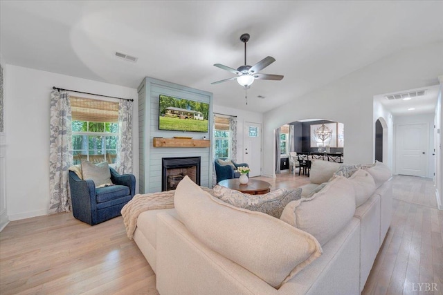 1369 Timberlake Dr, Lynchburg, VA 24502 - living room with arched walkways, vaulted ceiling, plenty of natural light, a fireplace, and a ceiling fan