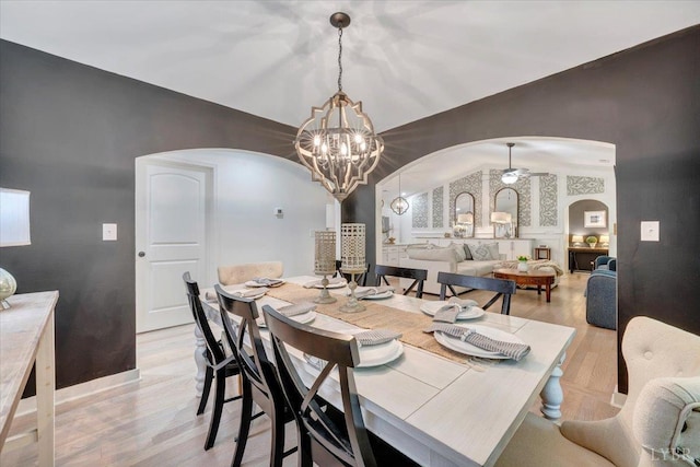 1369 Timberlake Dr, Lynchburg, VA 24502 - dining area with arched walkways, a chandelier, light wood finished floors, and vaulted ceiling