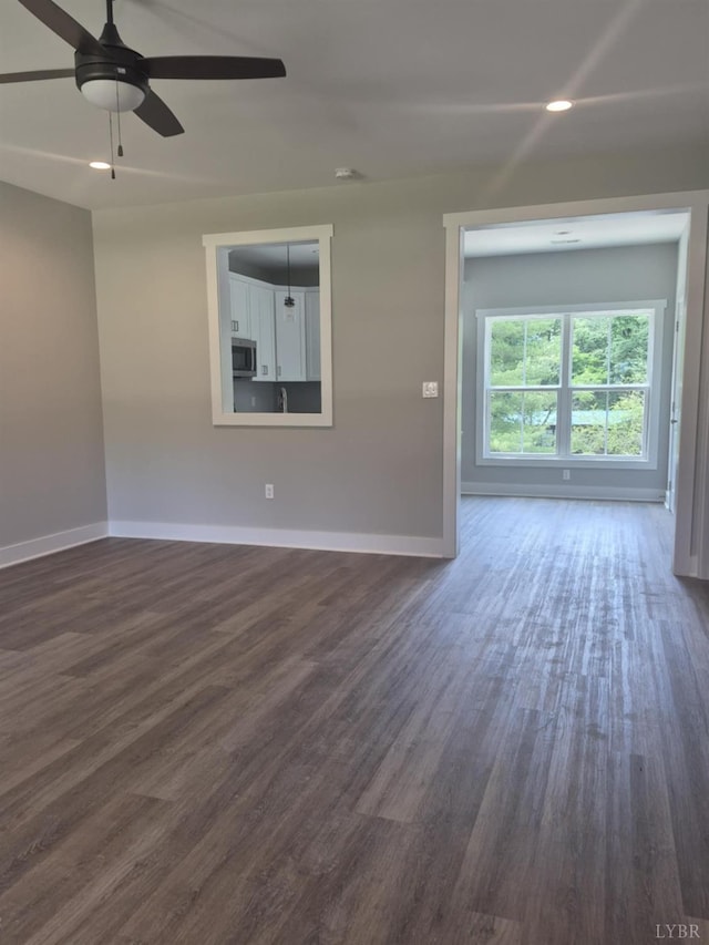 66 Pelt Ln, Evington, VA 24550 - spare room featuring baseboards, dark wood-style floors, and ceiling fan