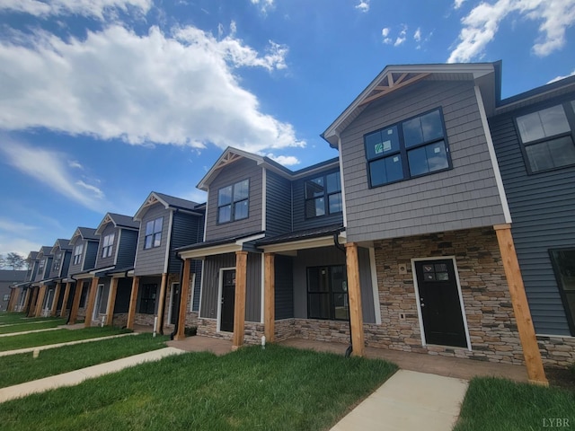 66 Pelt Ln, Evington, VA 24550 - townhome / multi-family property with stone siding, a front yard, and a residential view