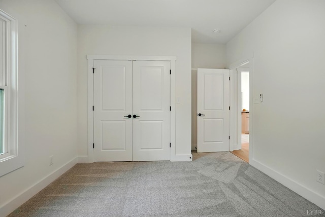 3580 Double Bridges Rd, Spout Spring, VA 24593 - unfurnished bedroom with light colored carpet, baseboards, and a closet