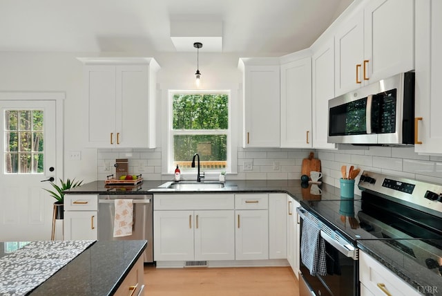 3580 Double Bridges Rd, Spout Spring, VA 24593 - kitchen featuring stainless steel appliances, a sink, white cabinets, and tasteful backsplash