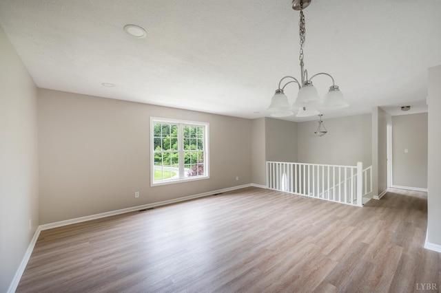 100 Creston Oaks Ct, Forest, VA 24551 - spare room featuring wood finished floors, a chandelier, and baseboards