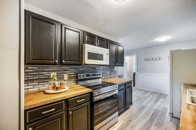 206 Huffmond St, Gretna, VA 24557 - kitchen with white appliances, butcher block counters, backsplash, and light wood-type flooring
