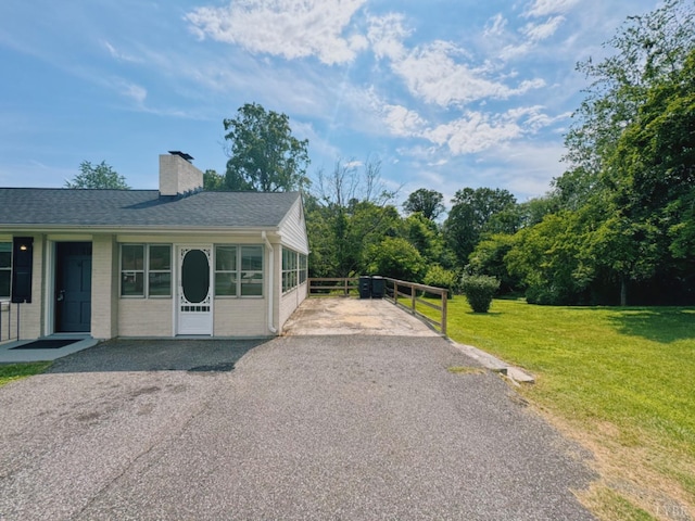 202 Bryant Rd, Lynchburg, VA 24502 - view of home's exterior featuring asphalt driveway, a lawn, a chimney, and roof with shingles