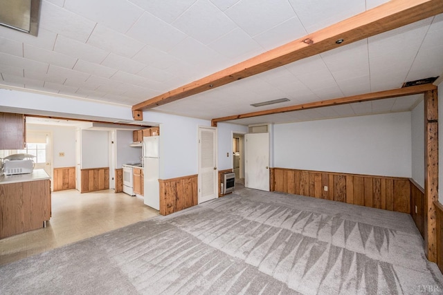 2207 Indian Hill Rd, Lynchburg, VA 24503 - below grade area with a wainscoted wall, wood walls, heating unit, light colored carpet, and freestanding refrigerator