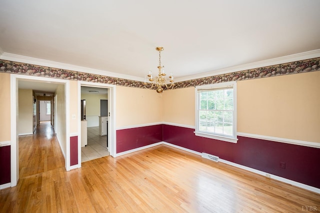 2207 Indian Hill Rd, Lynchburg, VA 24503 - empty room featuring a chandelier, light wood-style floors, and ornamental molding