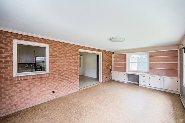 2207 Indian Hill Rd, Lynchburg, VA 24503 - unfurnished living room with built in study area, brick wall, and crown molding