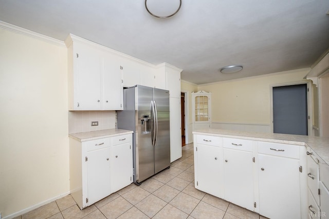 2207 Indian Hill Rd, Lynchburg, VA 24503 - kitchen featuring stainless steel fridge with ice dispenser, crown molding, light countertops, light tile patterned floors, and white cabinetry