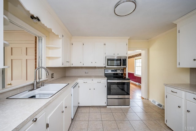 2207 Indian Hill Rd, Lynchburg, VA 24503 - kitchen featuring appliances with stainless steel finishes, light countertops, tasteful backsplash, and ornamental molding