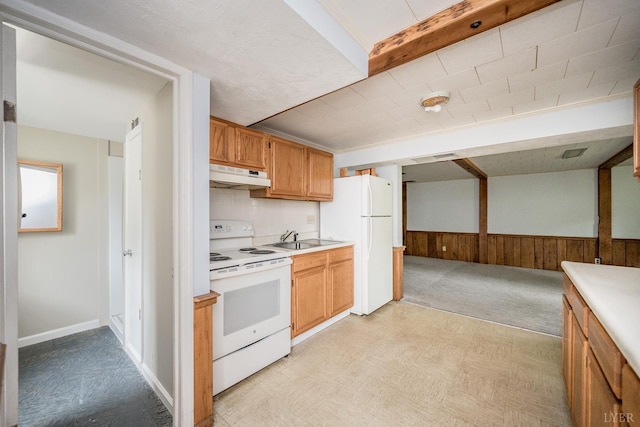 2207 Indian Hill Rd, Lynchburg, VA 24503 - kitchen with white appliances, under cabinet range hood, light countertops, light floors, and wooden walls
