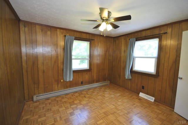 112 Half Moon Ln, Rustburg, VA 24588 - empty room with baseboard heating, wooden walls, and a ceiling fan