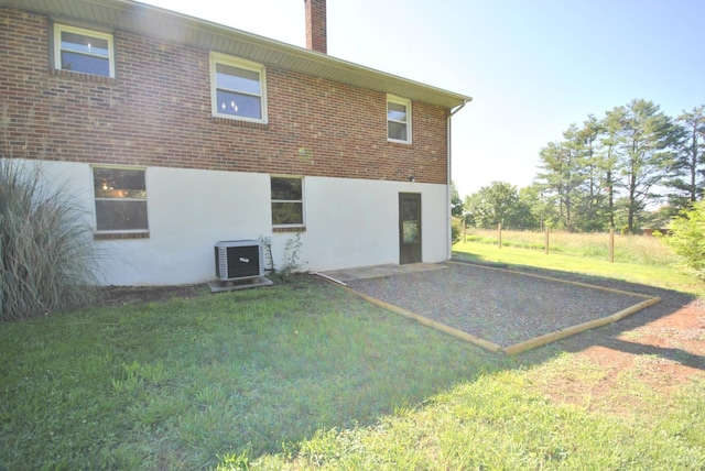 112 Half Moon Ln, Rustburg, VA 24588 - rear view of property featuring a lawn, stucco siding, a patio area, brick siding, and a chimney