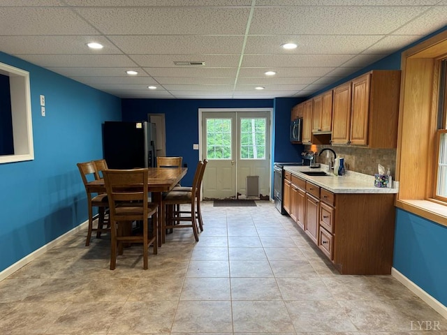 8 Northgate Ct, Lynch Station, VA 24571 - kitchen featuring stainless steel appliances, brown cabinets, light countertops, a paneled ceiling, and decorative backsplash