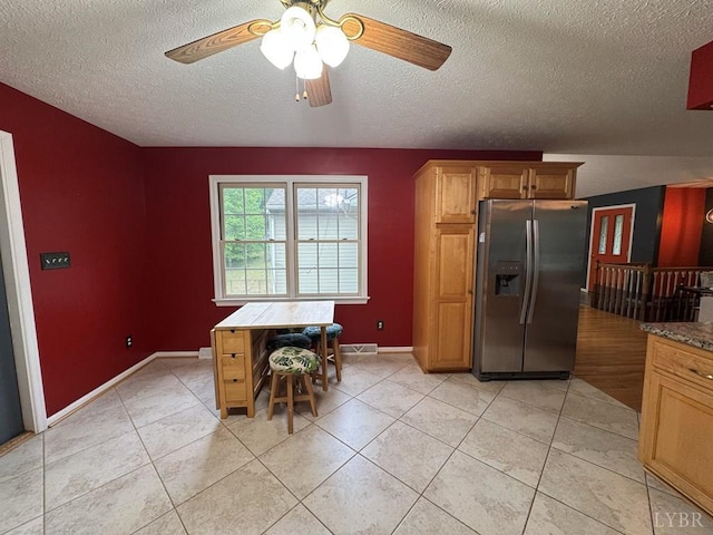 8 Northgate Ct, Lynch Station, VA 24571 - kitchen featuring stainless steel fridge, a textured ceiling, ceiling fan, light tile patterned flooring, and brown cabinets