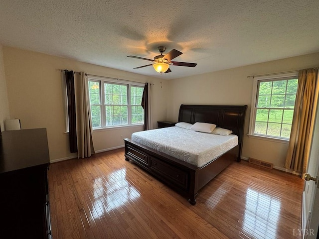 8 Northgate Ct, Lynch Station, VA 24571 - bedroom with light wood-style floors, a textured ceiling, and a ceiling fan