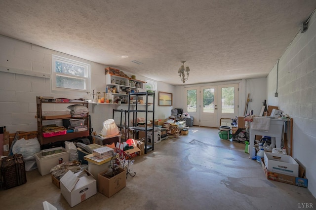 136 Timber Ridge Dr, Forest, VA 24551 - miscellaneous room featuring concrete floors, concrete block wall, a textured ceiling, and french doors