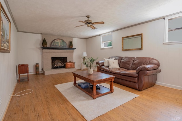 136 Timber Ridge Dr, Forest, VA 24551 - living room featuring wood finished floors, ornamental molding, a ceiling fan, and a fireplace