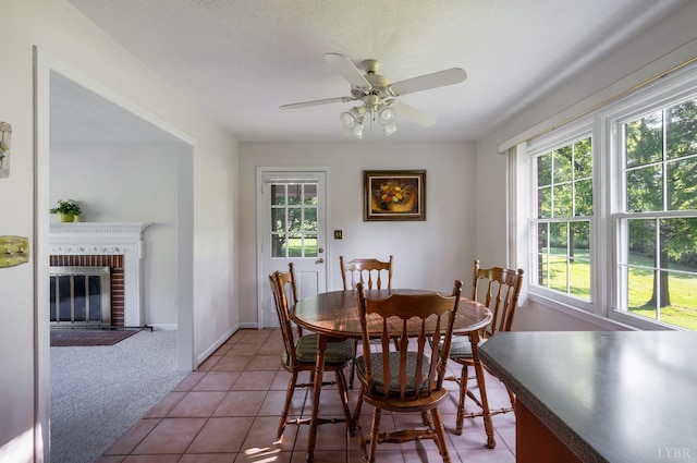 200 Middleboro Pl, Lynchburg, VA 24502 - tiled dining room featuring healthy amount of natural light, ceiling fan, carpet, and a brick fireplace