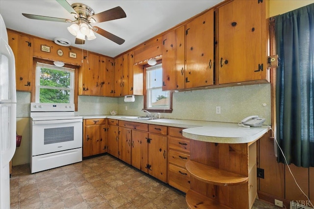 1250 Cifax Rd, Forest, VA 24551 - kitchen featuring white appliances, light countertops, tasteful backsplash, and brown cabinetry