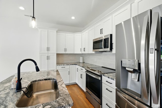 1036 Brownstone Dr, Forest, VA 24551 - kitchen featuring stainless steel appliances, tasteful backsplash, white cabinetry, wood finished floors, and recessed lighting