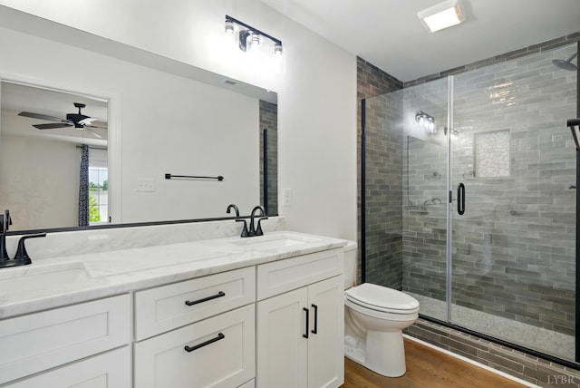 1036 Brownstone Dr, Forest, VA 24551 - bathroom featuring double vanity, a shower stall, wood finished floors, and a ceiling fan