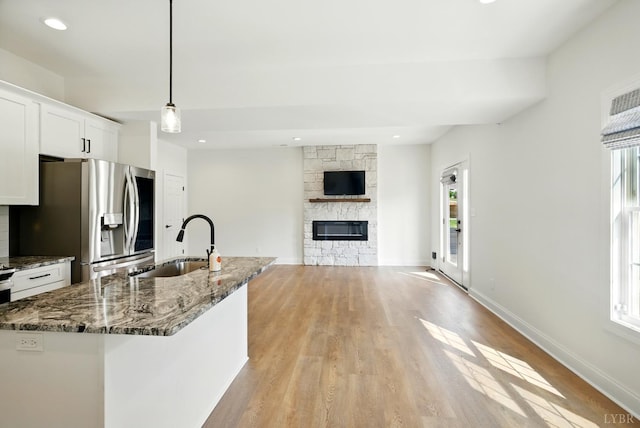1036 Brownstone Dr, Forest, VA 24551 - kitchen featuring stainless steel refrigerator with ice dispenser, healthy amount of natural light, light wood-type flooring, white cabinets, and recessed lighting