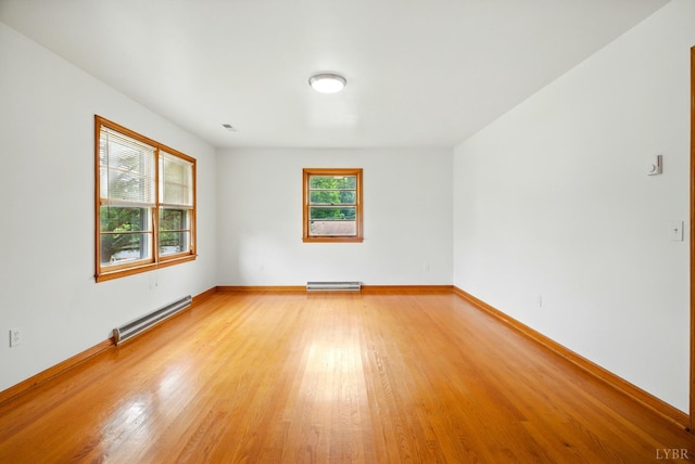 102 SE St, Brookneal, VA 24528 - unfurnished room featuring a baseboard radiator and light wood-style flooring